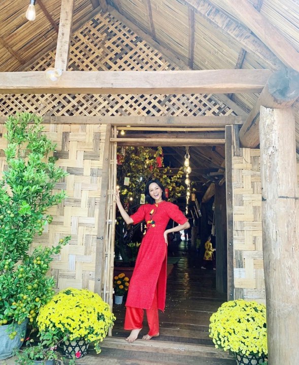 Hoa hậu H'Hen Niê nổi bật với chiếc áo dài màu đỏ rực. Từ bỏ mái tóc ngắn, người đẹp trông ngày càng điệu đà hơn với mái tóc dài quá vai.