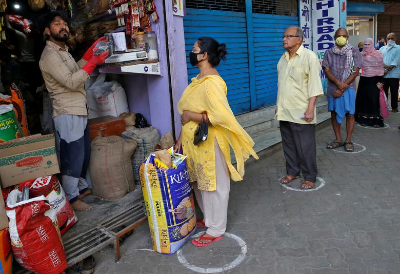 Tại một cửa hàng tạp hoá nhỏ ở Kolkata, người mua hàng cũng phải đứng cách xa nhau để giữ khoảng cách an toàn. Bức ảnh được chụp ngày 26/3.