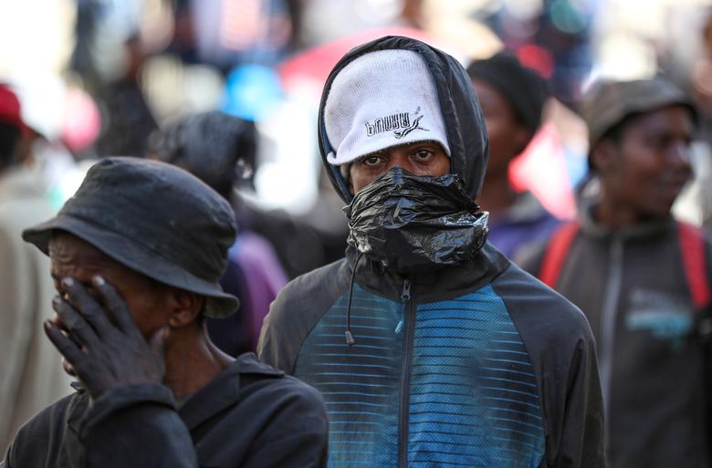 Một người vô gia cư dùng bao nilon quấn làm khẩu trang trong khi chờ đợi được đưa đến nơi trú ẩn dành cho người vô gia cư  ở thành phố Johannesburg, Nam Phi vào ngày 27/3.