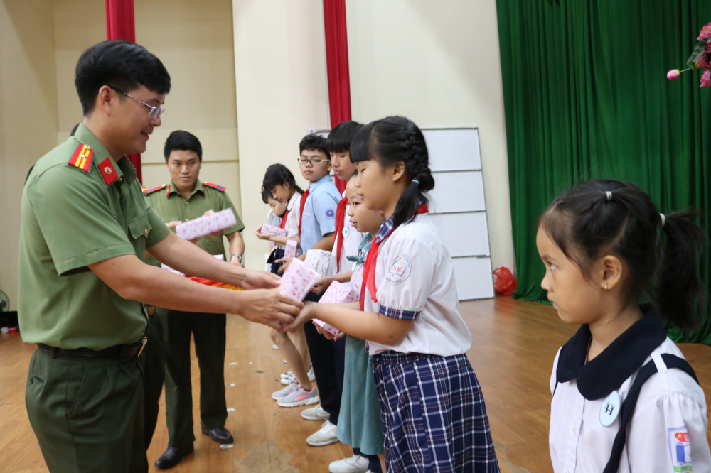 Thiếu tá Nguyễn Công Danh - Bí thư Đoàn thanh niên Công an TP.HCM - trao những suất học bổng tiếp sức học sinh trước thềm năm học mới. 