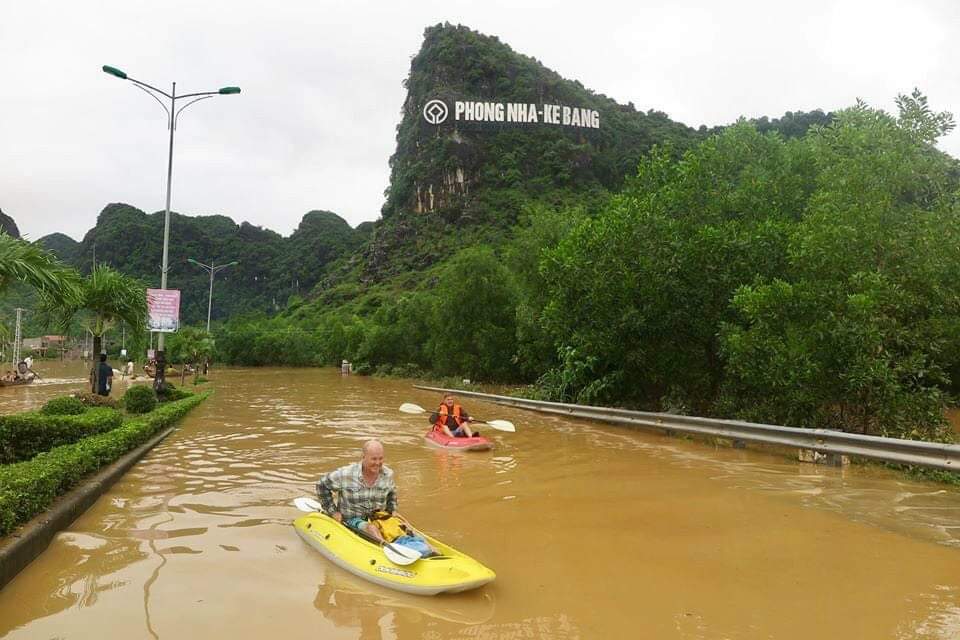 Du khách chèo thuyền giữa lúc nước lũ đang lên