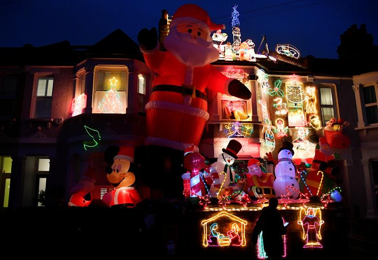 Người qua đường chiêm ngưỡng các nhân vật trang trí Giáng sinh bên ngoài một ngôi nhà ở London, Anh