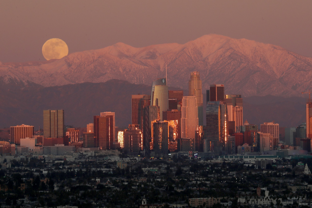 Những tòa nhà chọc trời khu trung tâm thành phố Los Angeles trên nền dãy núi San Gabriel trước lúc bình minh - Ảnh: Los Angeles Times