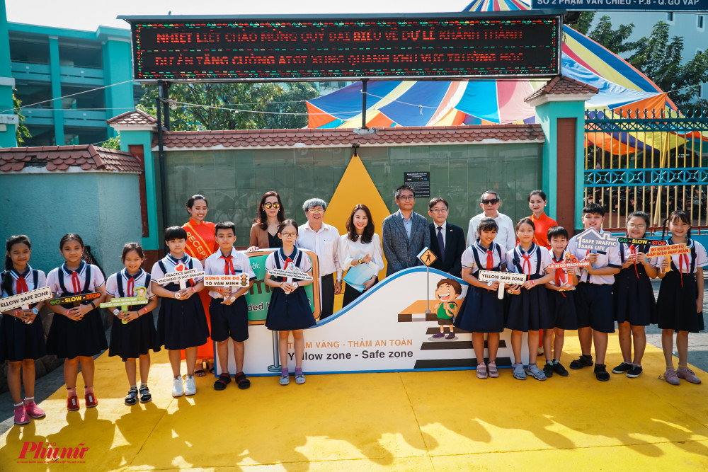 Đại diện lãnh đạo và các em học sinh chụp ảnh lưu niệm ngày khánh thành thảm vàng.
