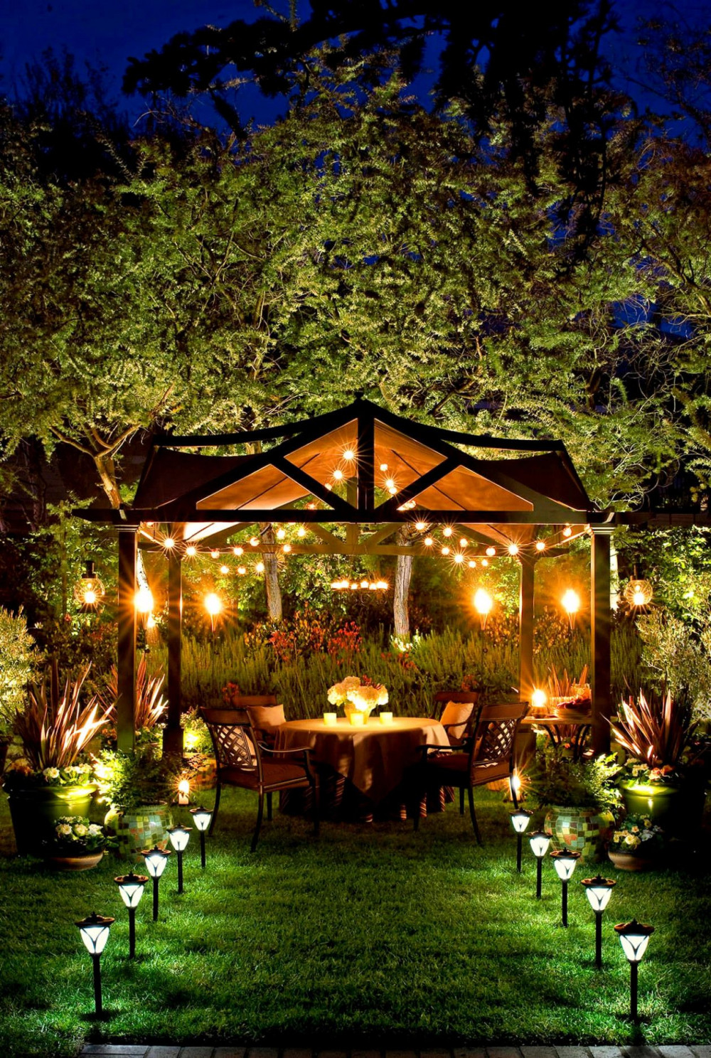 Bàn trà giữa vườn dưới ánh đèn lãng mạn