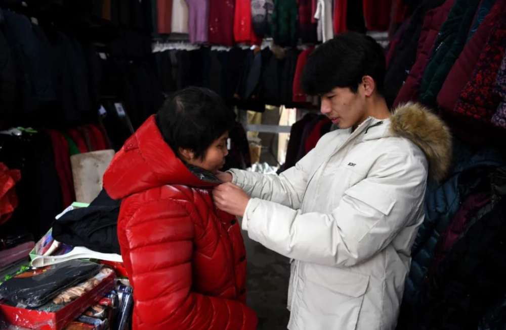Vào ngày 24/1, Cheng Chuan đã thử quần áo mới cho mẹ trong một cửa hàng quần áo và dùng số tiền dành dụm được từ việc học tập để mua quà năm mới cho mẹ. Ảnh Sohu