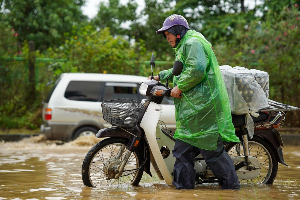 Nhiều xe máy bị chết máy , giải pháp tốt nhất người tham gia giao thông chọn là dắt xe cố gắng vượt qua vùng nước sâu, có những đoạn nước ngập sâu tới 1m.