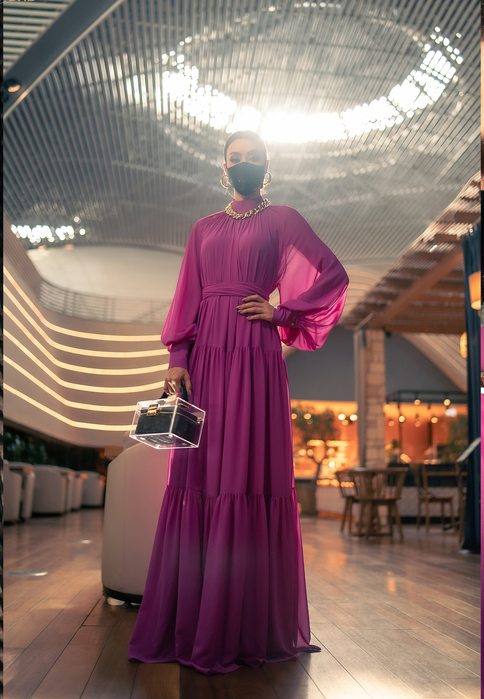 Trong phòng chờ chuẩn bị lên máy bay để tiếp tục hành trình đến Mỹ, Amanda thay một bộ váy khác màu hồng rực rỡ, phom dáng rộng, thoải mái, chất liệu mềm nhẹ của Avasa, cùng trang sức của hãng Pun và túi S'Uvimol có thiết kế rất độc đáo.