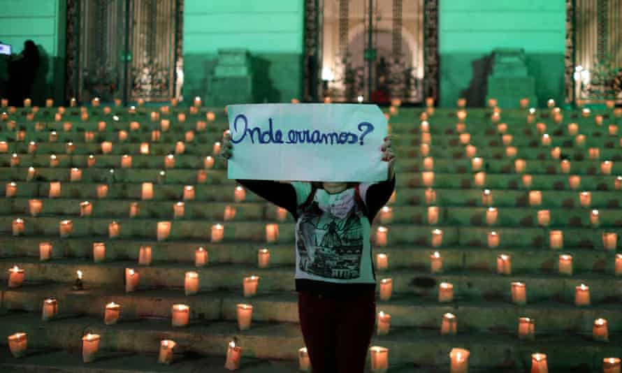 Một phụ nữ cầm một tấm biển trong sự kiện thắp nến để vinh danh 500.000 người đã chết vì coronavirus ở Brazil, ở Rio de Janeiro trong tuần này. Tấm biển viết: Chúng tôi đã sai ở đâu? - Ảnh: Reuters