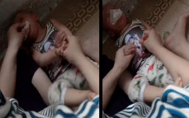 Bé trai bị cô giáo ghì chặt và nhét dẻ vào miệng (ảnh cắt từ clip)