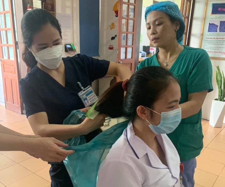 Nữ bác sĩ được đồng nghiệp cắt ngắn tóc trước lúc lên đường vào TPHCM