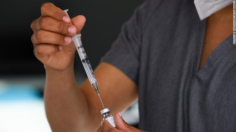 Nhân viên y tế tiêm vắc xin COVID-19 tại một phòng tiêm chủng di động ở Weingart East Los Angeles YMCA (California) ngày 14/5/2021 - Ảnh: CNN