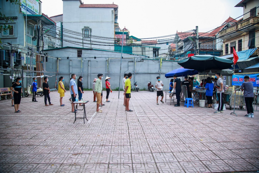 Ghi nhận của PV vào trưa 11/8, đã có rất đông người dân xếp thành 3 hàng trong khuôn viên nhà văn hóa 1-3 thuộc phường Phú Đô (Nam Từ Liêm, Hà Nội) để nhận những suất cơm hộp miễn phí.