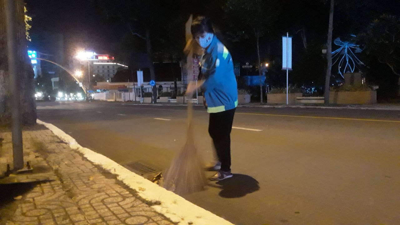 Một nữ nhân viên làm sạch đường phố về đêm tại khu vực trung tâm TP. Cần Thơ