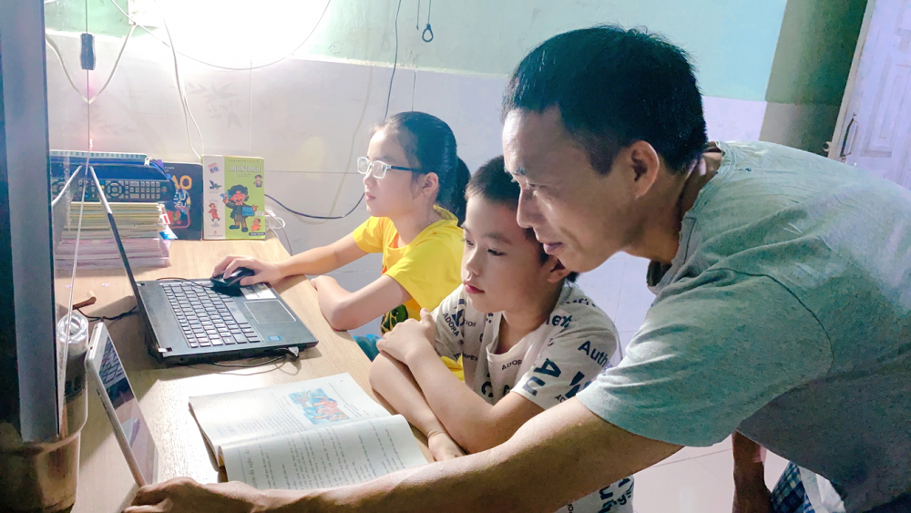 Cha mẹ phải theo sát để hỗ trợ con học online - Ảnh: Dương Bình