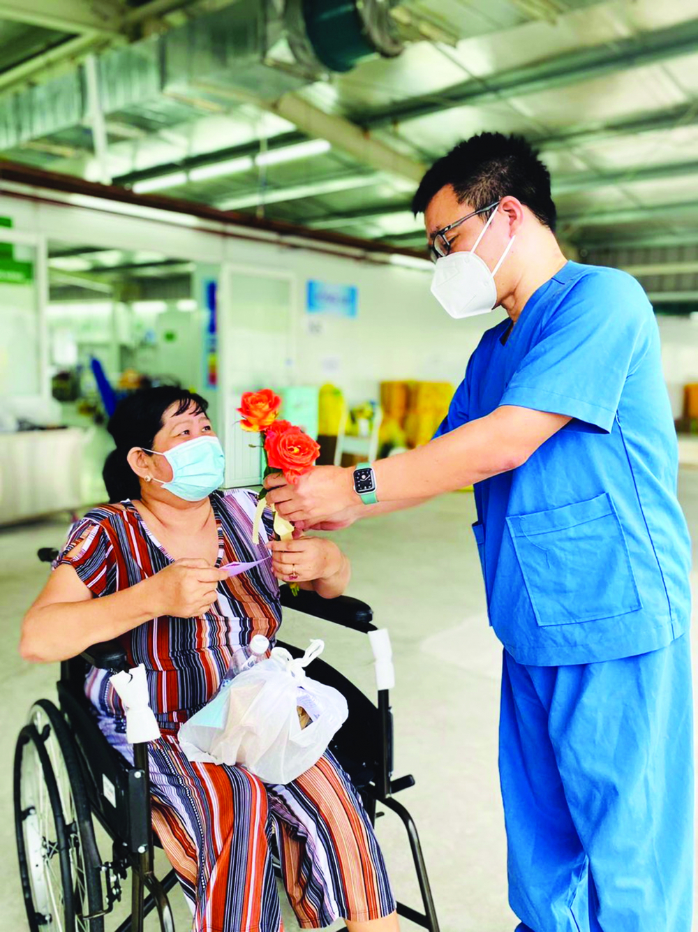Bác sĩ Lê Minh Khôi, Bệnh viện Đại học Y Dược TP.HCM, tặng hoa cho nữ bệnh nhân được xuất viện đúng vào ngày 20/10 - ẢNH: BÁC SĨ CUNG CẤP