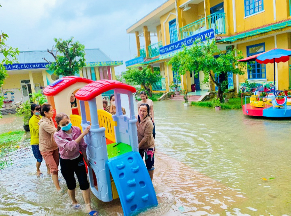 Các cô giáo trường mầm non xã Quảng An, H.Quảng Điền, tỉnh Thừa Thiên - Huế dọn dẹp sân trường bị ngập nước trong ngày 24/10 - Ảnh: Thuận Hóa