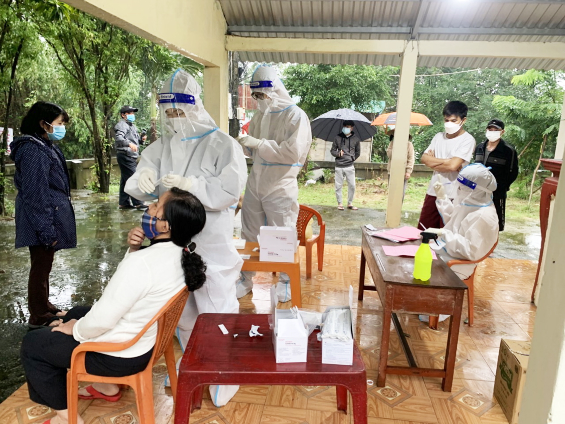 Lực lượng phản ứng nhanh của Trung tâm Kiểm soát bệnh tật tỉnh Thừa Thiên - Huế cùng các thành viên PUN75 lấy mẫu xét nghiệm ở Cồn Hến, P.Vỹ Dạ, TP.Huế dưới trời mưa to ẢNH: T.HÓA