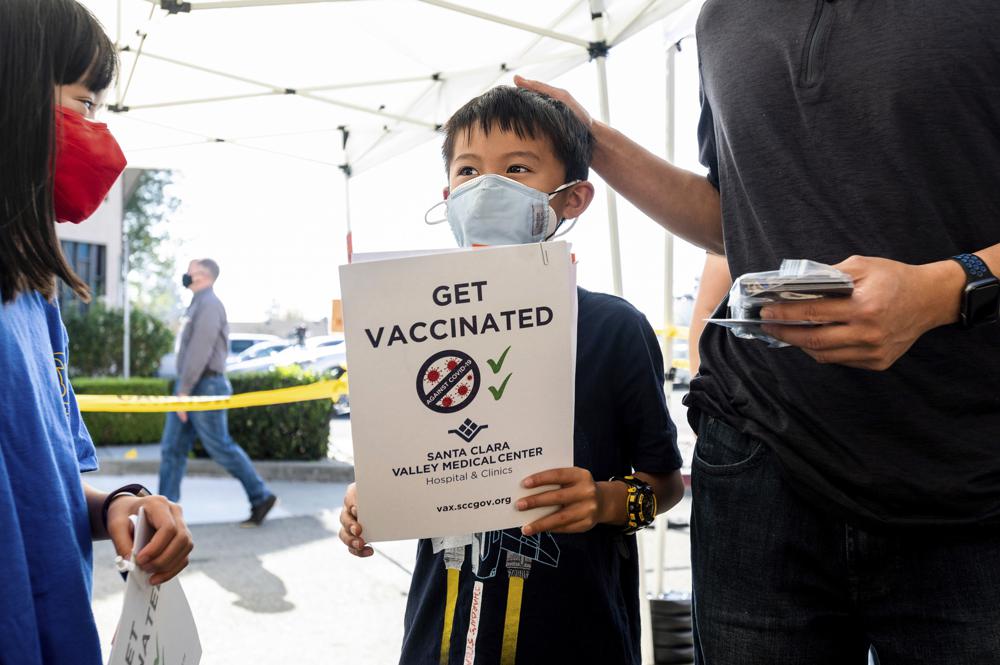 Cậu bé Matthew Yip, 8 tuổi, vừa được tiêm mũi tiêm vắc xin COVID-19 dành cho trẻ em từ 5 đến 11 tuổi. Nước Mỹ đang tăng tốc với mục tiêu  - Ảnh: Noah Berger