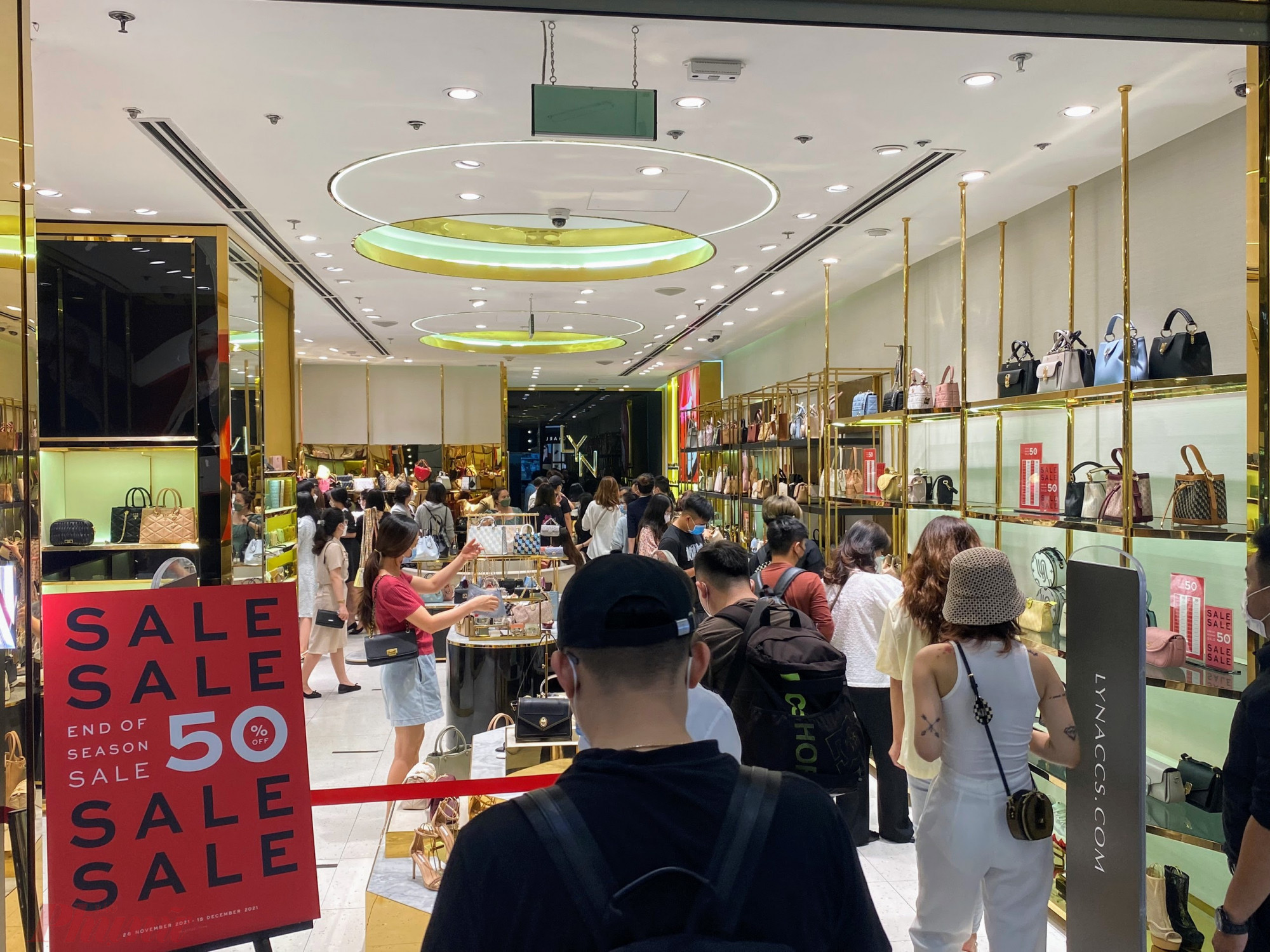 Đến khoảng 10h30 cửa hàng thời trang nữ tại TTTM quận 1 đã bắt đầu đông khách, cửa hàng này đang áp dụng chính sách giảm giá đến 50% các mặt hàng ví, giày, dép nữ.