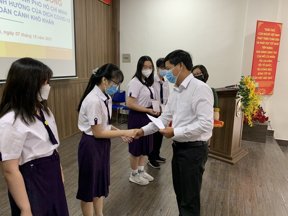 Chủ tịch Công đoàn EVNHCMC Lê Văn Minh trao học bổng cho 6 em học sinh Trường THPT Nguyễn Thị Minh Khai có hoàn cảnh đặc biệt vì COVID-19 - Ảnh: EVNHCMC