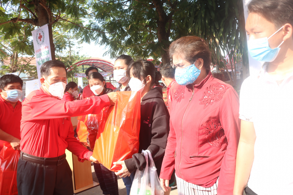 Ông Trần Văn Tuấn - Phó chủ tịch Hội Chữ Thập đỏ TP.HCM - tặng quà cho người dân. 