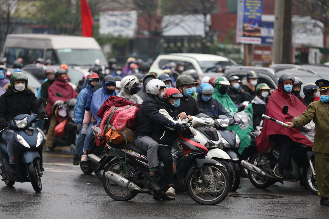 Hầu hết các xe máy đều chở đầy đồ mang theo về Hà Nội. Việc di chuyển càng khó khăn, nhiều gia đình còn cho người ngồi chênh vênh trên các vali quần áo.