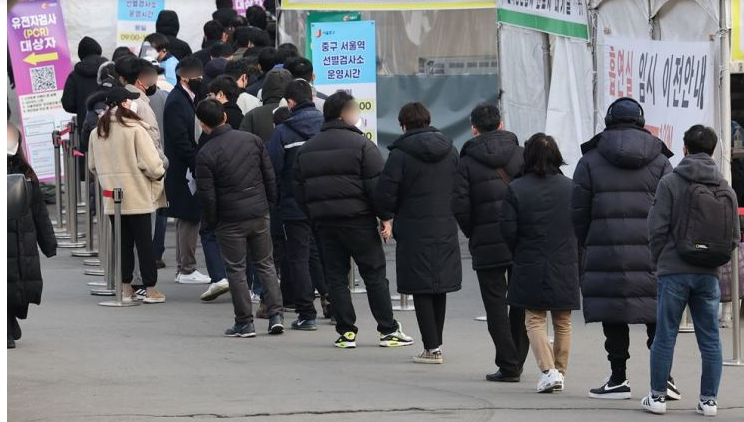 Mọi người xếp hàng chờ xét nghiệm coronavirus tại một phòng khám sàng lọc cửa sổ bật lên ở phía trước ga Seoul, thứ Sáu. Yonhap