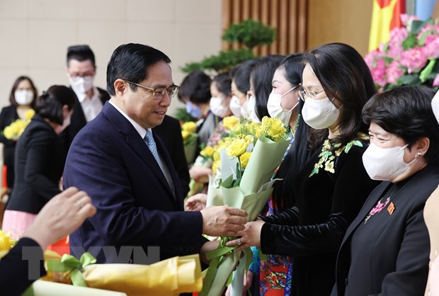 Thủ tướng Phạm Minh Chính chúc mừng, tặng hoa các đại diện nữ lãnh đạo quản lý, trí thức và văn nghệ sỹ tiêu biểu. (Ảnh: Dương Giang/TTXVN)
