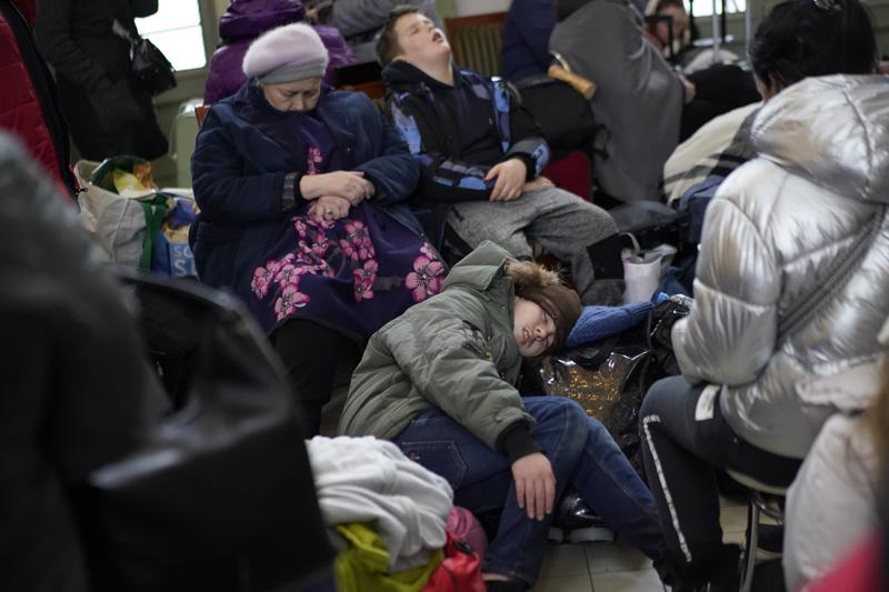 Phụ nữ và trẻ em Ukraine đang nằm vạ vật bên trong một nhà ga xe lửa của nước láng giềng Ba Lan - Ảnh: Daniel Cole/AP