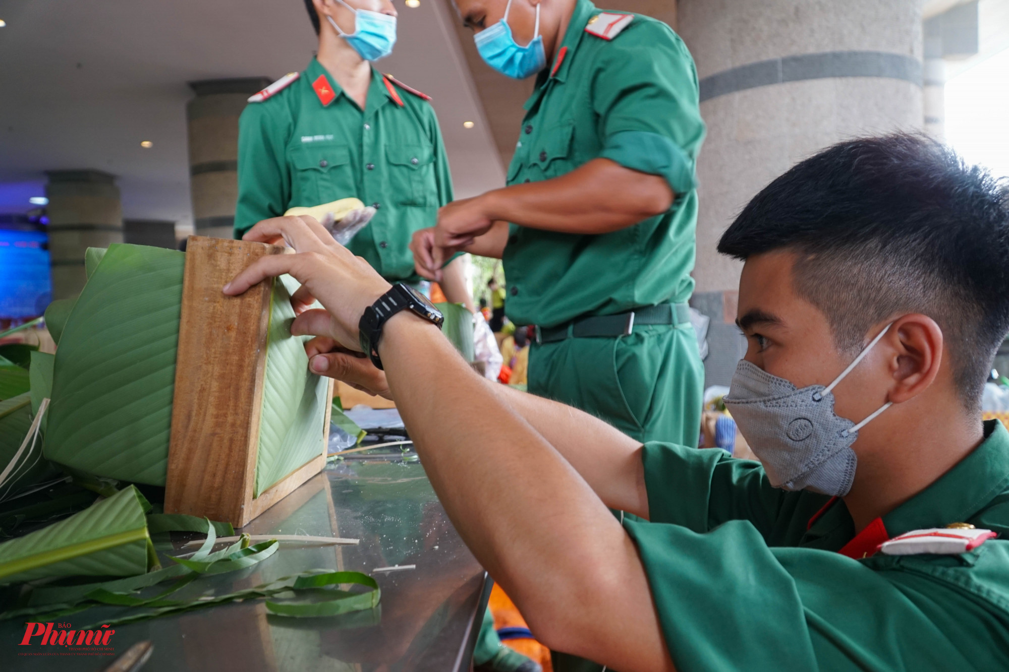 Một chiến sĩ quân đội canh kỹ chiều dài của chiếc bánh