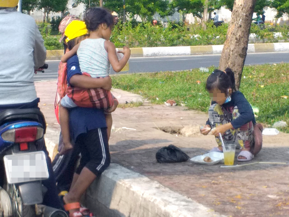 Nhiều trẻ em đi xin ăn trên đường  Nguyễn Hữu Thọ, Q.7, TP.HCM - Ảnh: T.Tri