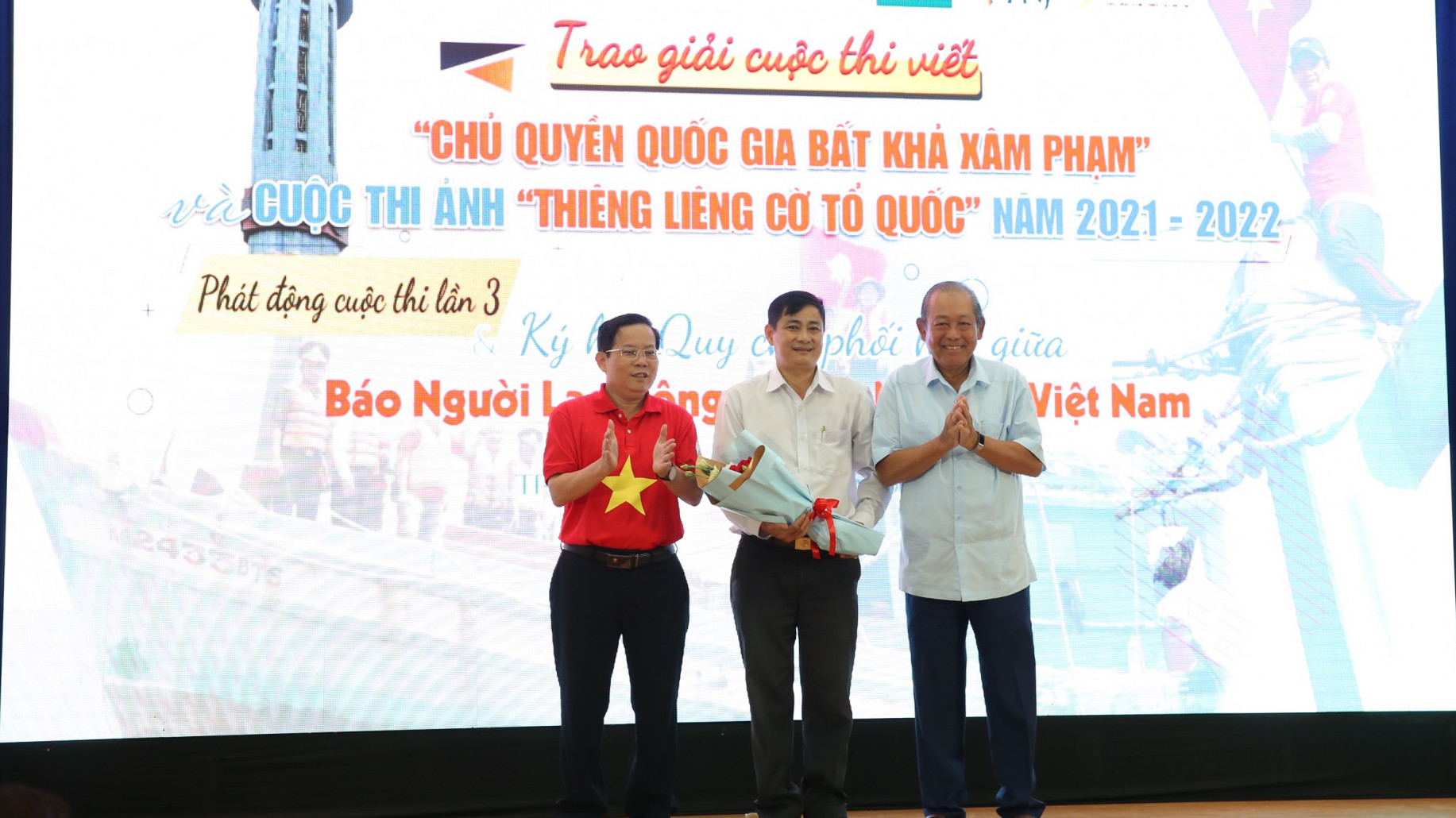 Tác giả Nguyễn Trung Trực (giữa) nhận giải Nhất cuộc thi ảnh 'Thiêng liêng lá cờ Tổ quốc với bộ ảnh Tổ quốc trong trái tim người lính mũ nồi xanh