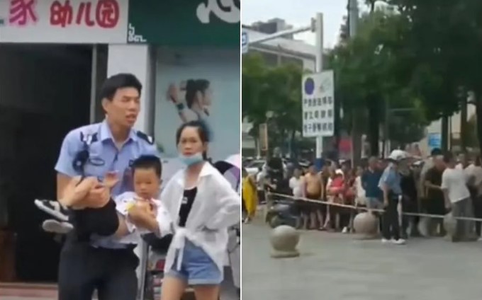 Một sĩ quan cảnh sát có thể được nhìn thấy trong đoạn video quay cảnh bế một đứa trẻ nhỏ xíu trên tay lên xe cứu thương. ẢNH: SCREENGRABS TỪ TWITTER