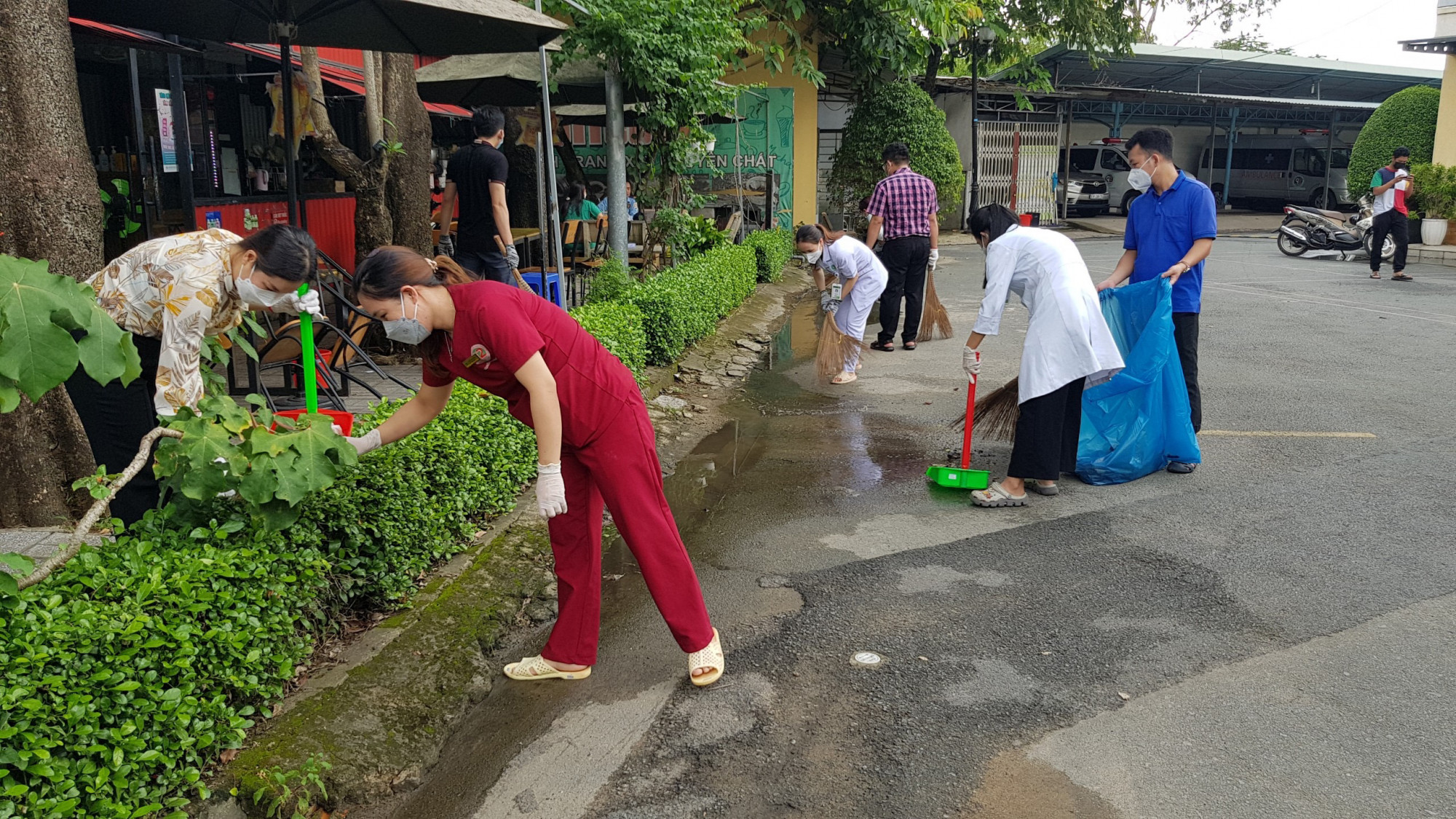 Người dân và nhân viên y tế tại Bệnh viện Lê Văn Thịnh chung tay dọn dẹp vệ sinh, thu gom rác thải. 