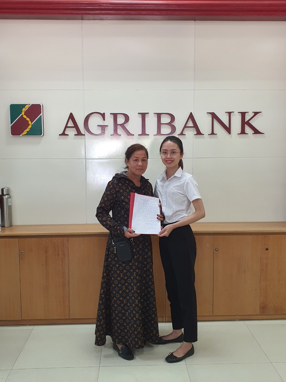 Bà Nguyễn Thị Quý cảm ơn lãnh đạo Agribank Tây Nghệ An và giao dịch viên Nguyễn Thị Cẩm Vân, nhờ sự tư vấn và ngăn chặn kịp thời mà bà tránh bị mất một khoản tiền lớn - Ảnh: Agribank