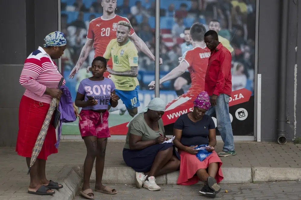 Khách hàng đặt cược bên ngoài một cửa hàng cá cược thể thao ở khu vực Soweto của thanh phố Johannesburg, Nam Phi