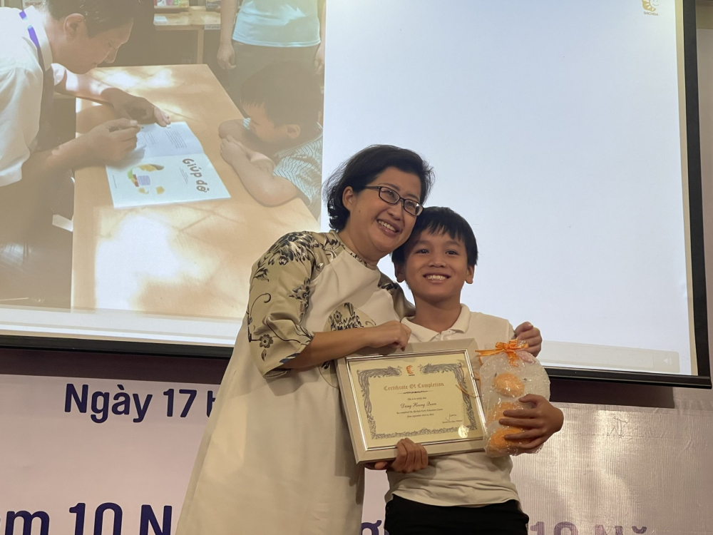 Bà Jeannie Ho Chan trao bằng tốt nghiệp cho bé Hoàng Quân