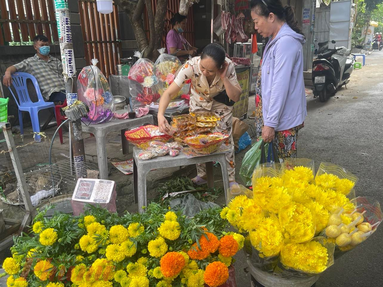 Nhiều điểm bán hoa bán kèm thêm giấy vàng mã cúng Ông Táo - Ảnh: Nguyễn Cẩm