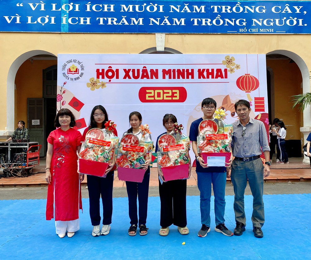 Ông Trần Minh Hải, Phó trưởng Ban Truyền thông (bìa phải), đại diện EVNHCMC trao quà tết cho các em Trường PTTH Nguyễn Thị Minh Khai có hoàn cảnh đặc biệt vì COVID-19 - Ảnh: EVNHCMC