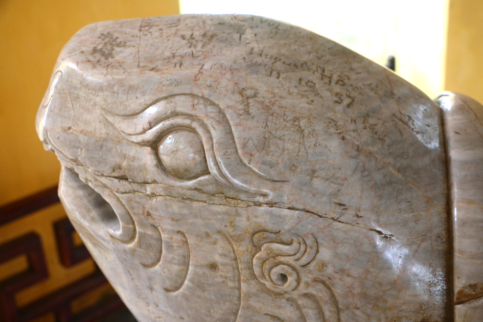Đầu rùa nơi đặt tấm bia “Ngự kiến Thiên Mụ tự” bị khắc chữ đến mức khó có thể khôi phục - ẢNH: T.H.