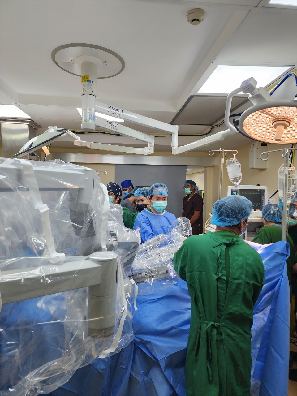 Bác sĩ Nguyễn Phú Hữu, Bệnh viện Bình Dân đang hướng dẫn các bác sĩ Philippines  tại bệnh viện CGHMC cách đặt các cánh tay robot vào vị trí phù hợp để phẫu thuật, ảnh BVCC