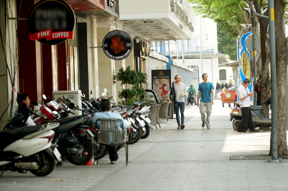 Xe máy được xếp gọn chừa một phần vỉa hè cho người đi bộ trên đường Nguyễn Huệ - Ảnh: Tam Nguyên