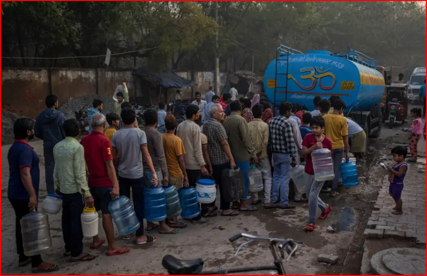 Mọi người chờ đến lượt lấy nước uống từ một xe bồn chở nước di động vào Ngày Nước Thế giới tại một khu dân cư ở New Delhi, Ấn Độ, hôm thứ Tư. Ảnh: Altaf Qadri/AP
