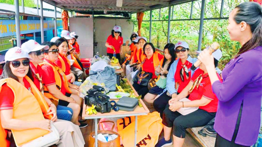 Chị Lường Thị Hiền (áo tím, bìa phải) làm hướng dẫn viên du lịch, đưa du khách tham quan phá Tam Giang