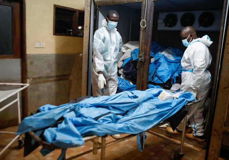 Một công nhân nhận thi thể của những người theo giáo phái được khai quật tại nhà xác bệnh viện quận Malindi, ngày 26 tháng 4. Hội Chữ thập đỏ đã quyên góp một thùng chứa lạnh trên một chiếc xe tải để giúp bảo quản một số thi thể vì nhà xác hiện đã quá đầy. REUTERS/Monicah Mwangi