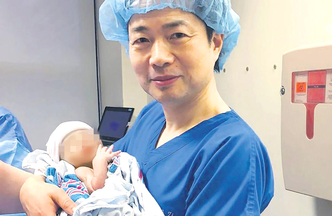 Bác sĩ John Zhang - người sáng lập Trung tâm sinh sản Hy vọng mới ở  thành phố New York, Mỹ - bế em bé có 3 cha mẹ đầu tiên trên thế giới ẢNH: NEW HOPE FERTILITY CENTER