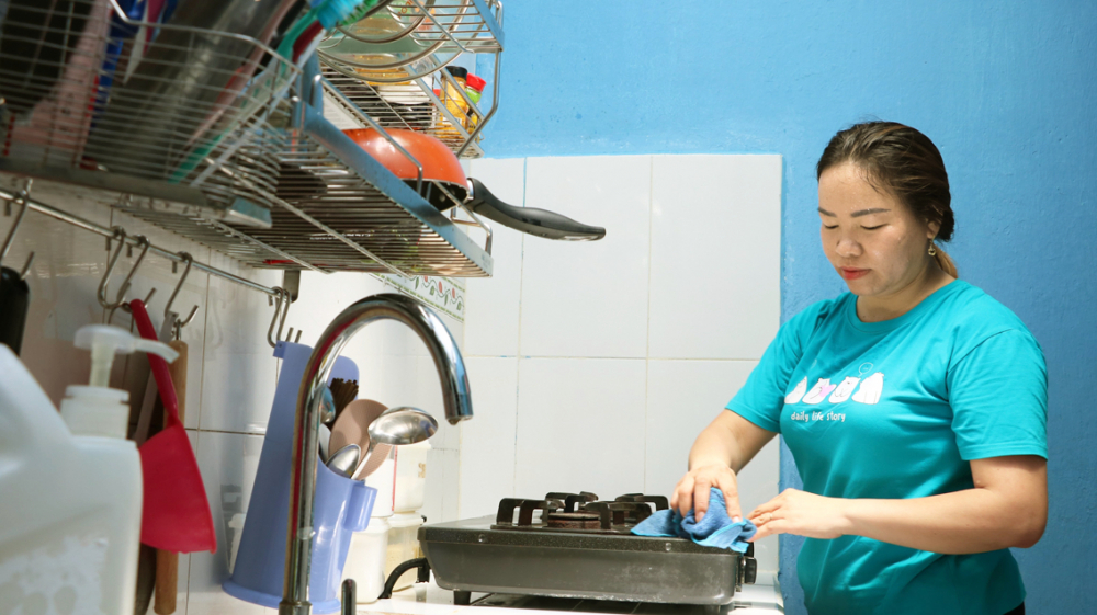 Chị Đoàn Thị Hằng thích thú với góc bếp mới được Quận hội Tân Bình trao tặng  - ẢNH: TRANG THƯ
