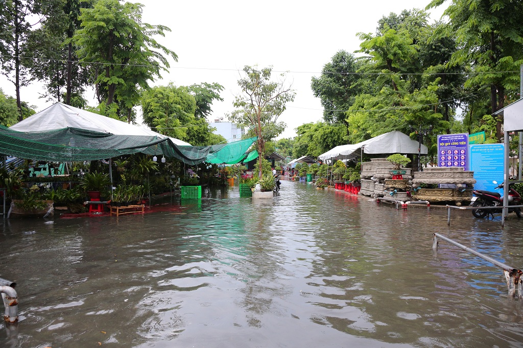 Đến 15g cùng ngày, trên địa bàn TPHCM vẫn còn mưa nhỏ, một số khu vực kinh doanh bị ngập.