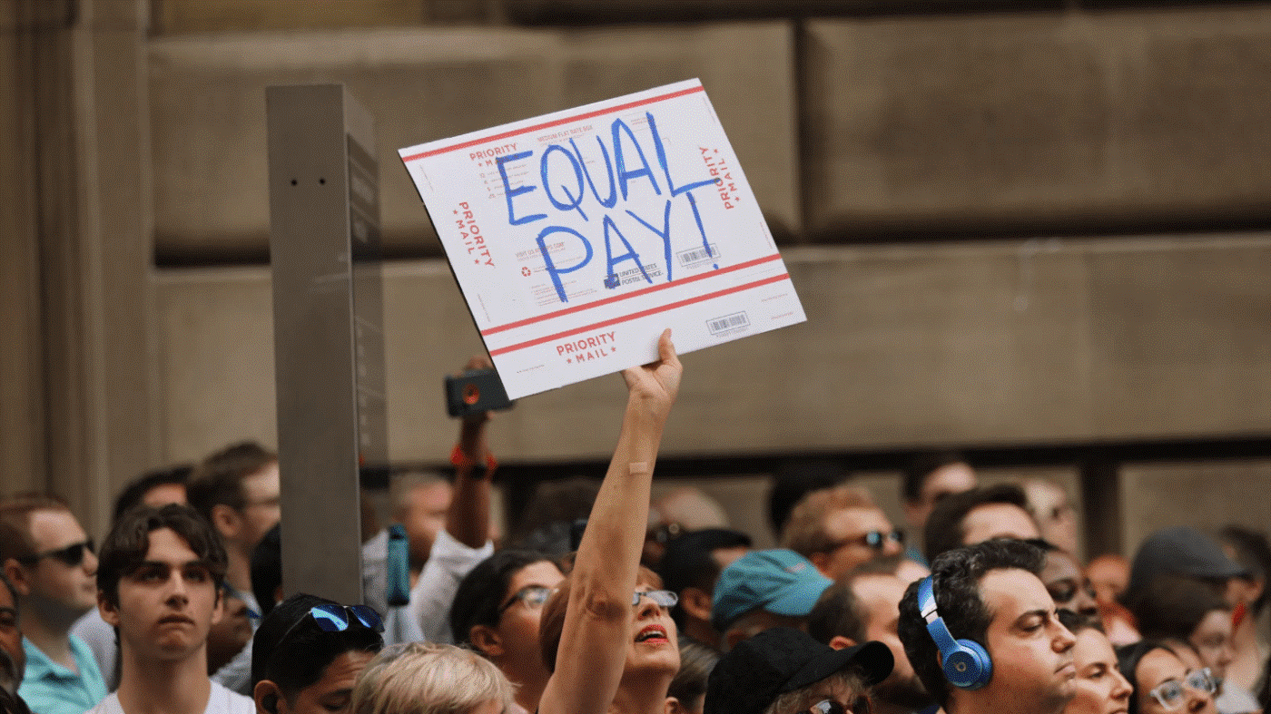 Một phụ nữ tuần hành giương biểu ngữ yêu cầu được trả lương bình đẳng – Ảnh: Getty Images